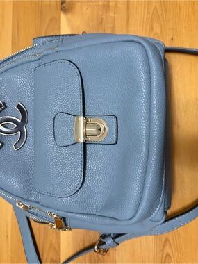 Fashion inspired Pebbled Light Blue Leather Backpack with Gold Hardware